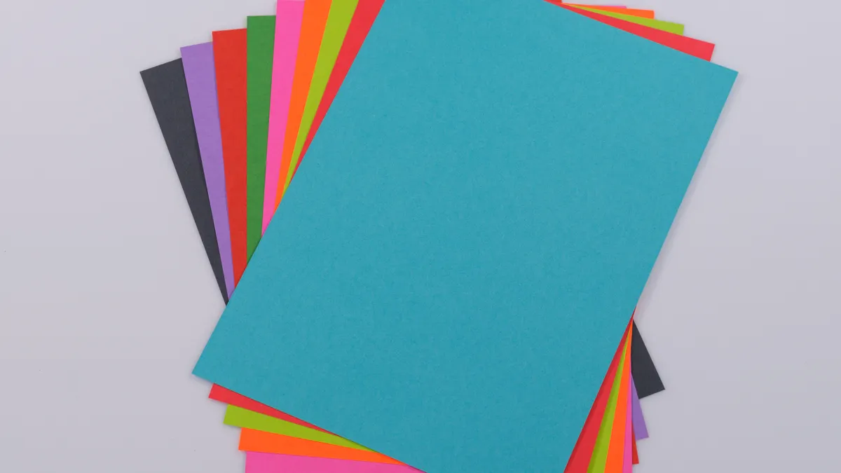 Scrapbooking Paper Types Explained: Cardstock, Patterned Paper, and Specialty Paper Stack of colorful paper sheets