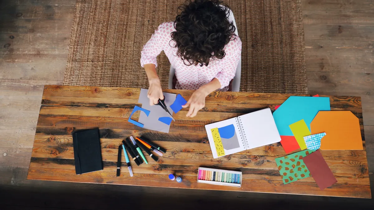 Overhead view of scrapbooking supplies and colorful paper pieces